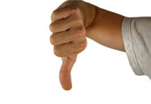 Палец вниз. Порицание. Отрицательная оценка. Изображение из фотобанка